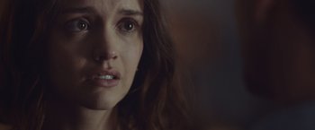 Movie still from “Little Fish” (2020), directed by Chad Hartigan – A woman's face in a dark room; Close Up shot, Over the shoulder angle