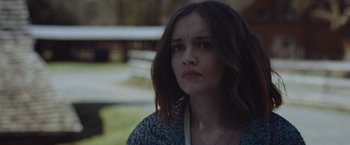 Movie still from “Little Fish” (2020), directed by Chad Hartigan – A woman with long brown hair is looking to her left; Close Up shot, Over the shoulder angle