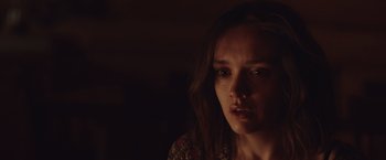 Movie still from “Little Fish” (2020), directed by Chad Hartigan – A young woman with long brown hair stares into the camera; Close Up shot, Over the shoulder angle