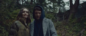 Movie still from “Little Fish” (2020), directed by Chad Hartigan – A man and a woman standing next to each other in the woods; Close Up shot, Over the shoulder angle