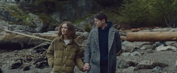 Movie still from “Little Fish” (2020), directed by Chad Hartigan – A man and a woman holding hands while standing next to each other; Medium shot, Over the shoulder angle