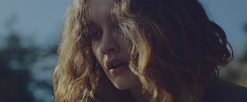 Movie still from “Little Fish” (2020), directed by Chad Hartigan – A woman's face with curly hair; Extreme Close Up shot, Low angle