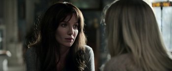 Movie still from “Malignant” (2021), directed by James Wan – A woman with long brown hair is talking to another woman; Close Up shot, Over the shoulder angle
