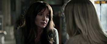 Movie still from “Malignant” (2021), directed by James Wan – A woman talking to another woman in front of a mirror; Close Up shot, Over the shoulder angle