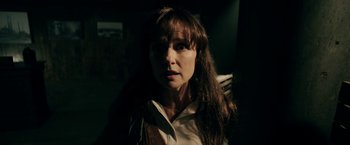 Movie still from “Malignant” (2021), directed by James Wan – A person with long brown hair; Close Up shot, Over the shoulder angle