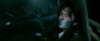 Movie still from “Malignant” (2021), directed by James Wan – A woman with duct tape around her mouth; Close Up shot, High angle