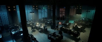 Movie still from “Malignant” (2021), directed by James Wan – A room filled with lots of tables and chairs; Extreme Wide shot, High angle