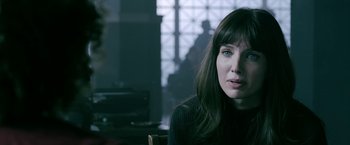 Movie still from “Malignant” (2021), directed by James Wan – A woman sitting in front of a window looking at the camera; Close Up shot, Over the shoulder angle