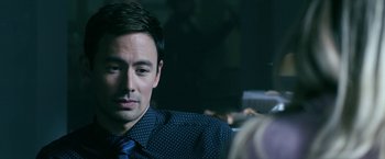 Movie still from “Malignant” (2021), directed by James Wan – A person wearing a suit and tie; Close Up shot, Over the shoulder angle