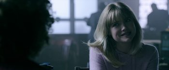 Movie still from “Malignant” (2021), directed by James Wan – A woman sitting in a room with a window in the background; Close Up shot, Over the shoulder angle