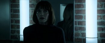 Movie still from “Malignant” (2021), directed by James Wan – A woman standing in front of a bathroom mirror; Close Up shot, Over the shoulder angle