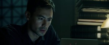 Movie still from “Malignant” (2021), directed by James Wan – A person using a laptop computer; Close Up shot, High angle