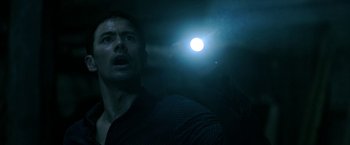 Movie still from “Malignant” (2021), directed by James Wan – A person with a flashlight; Close Up shot, Low angle