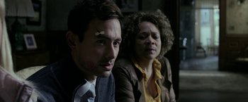 Movie still from “Malignant” (2021), directed by James Wan – A man and a woman sitting next to each other; Close Up shot, Over the shoulder angle