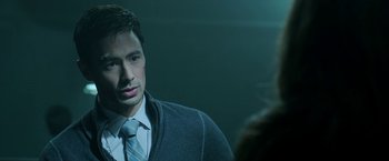 Movie still from “Malignant” (2021), directed by James Wan – A man wearing a suit and tie in front of a woman; Close Up shot, Over the shoulder angle