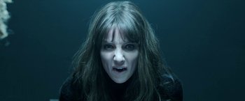 Movie still from “Malignant” (2021), directed by James Wan – A person with long dark hair; Close Up shot, Overhead angle