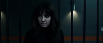 Movie still from “Malignant” (2021), directed by James Wan – A woman with long black hair stares into the camera; Close Up shot, Over the shoulder angle