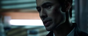 Movie still from “Malignant” (2021), directed by James Wan – A man's face in the dark; Close Up shot, Over the shoulder angle