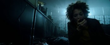 Movie still from “Malignant” (2021), directed by James Wan – A woman sitting on a bed next to a man; Medium shot, Low angle