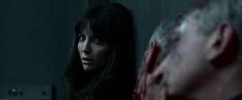 Movie still from “Malignant” (2021), directed by James Wan – A person in a dark room; Close Up shot, Over the shoulder angle