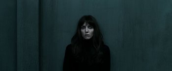 Movie still from “Malignant” (2021), directed by James Wan – A woman in a black shirt is looking at the camera; Close Up shot, Overhead angle