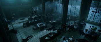 Movie still from “Malignant” (2021), directed by James Wan – An office with a lot of desks in the middle of the room; Extreme Wide shot, High angle