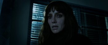 Movie still from “Malignant” (2021), directed by James Wan – A person with long brown hair; Close Up shot, Low angle