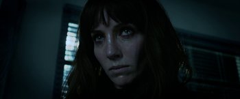 Movie still from “Malignant” (2021), directed by James Wan – A person with long brown hair; Close Up shot, Low angle