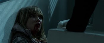 Movie still from “Malignant” (2021), directed by James Wan – A young girl with blood all over her face; Close Up shot, Over the shoulder angle