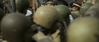 Movie still from “Malik” (2021), directed by Mahesh Narayanan – A group of people standing next to each other with helmets on; Close Up shot, Over the shoulder angle