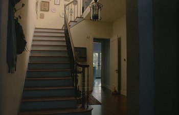 Movie still from “Marcel the Shell with Shoes On” (2021), directed by Dean Fleischer Camp – A view of a staircase in a house; Extreme Wide shot, Low angle