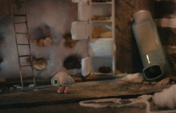 Movie still from “Marcel the Shell with Shoes On” (2021), directed by Dean Fleischer Camp – A toy snail sitting on top of a floor; Extreme Close Up shot, High angle