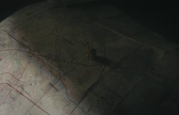 Movie still from “Marcel the Shell with Shoes On” (2021), directed by Dean Fleischer Camp – A pencil sitting on top of a map; Extreme Close Up shot, Overhead angle