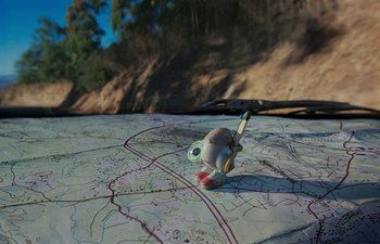 Movie still from “Marcel the Shell with Shoes On” (2021), directed by Dean Fleischer Camp – A toy on a map of a road; Extreme Close Up shot, High angle