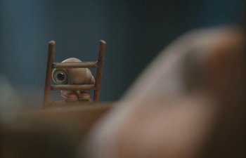 Movie still from “Marcel the Shell with Shoes On” (2021), directed by Dean Fleischer Camp – A wooden chair sitting in the middle of a room; Extreme Close Up shot, High angle