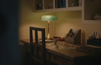Movie still from “Marcel the Shell with Shoes On” (2021), directed by Dean Fleischer Camp – A desk with a lamp on top of it; Wide shot, High angle