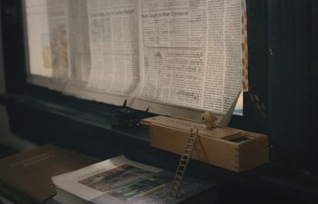 Movie still from “Marcel the Shell with Shoes On” (2021), directed by Dean Fleischer Camp – A wooden ladder sitting on top of a table; Extreme Close Up shot, High angle