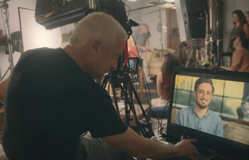 Movie still from “Marcel the Shell with Shoes On” (2021), directed by Dean Fleischer Camp – A man sitting in front of a computer screen; Close Up shot, Over the shoulder angle