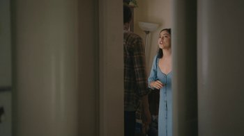 Movie still from “Marcel the Shell with Shoes On” (2021), directed by Dean Fleischer Camp – A woman in a blue dress standing next to a man; Medium shot, Over the shoulder angle