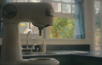 Movie still from “Marcel the Shell with Shoes On” (2021), directed by Dean Fleischer Camp – A coffee maker sitting on top of a kitchen counter next to a window; Extreme Close Up shot, Low angle