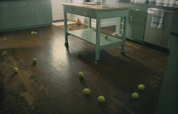 Movie still from “Marcel the Shell with Shoes On” (2021), directed by Dean Fleischer Camp – Many tennis balls on the floor; Wide shot, High angle
