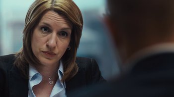 Movie still from “Margin Call” (2011), directed by J.C. Chandor – A person wearing a suit and tie; Close Up shot, Over the shoulder angle