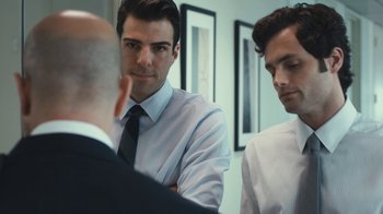 Movie still from “Margin Call” (2011), directed by J.C. Chandor – A man in a white dress shirt and a black tie; Medium shot, Over the shoulder angle