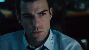 Movie still from “Margin Call” (2011), directed by J.C. Chandor – A person wearing a shirt and ear phones; Close Up shot, Overhead angle