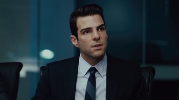 Movie still from “Margin Call” (2011), directed by J.C. Chandor – A person wearing a suit and tie; Close Up shot, Over the shoulder angle