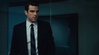 Movie still from “Margin Call” (2011), directed by J.C. Chandor – A man wearing a suit and tie standing in a room; Close Up shot, Over the shoulder angle