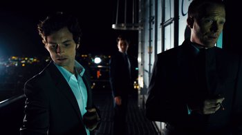Movie still from “Margin Call” (2011), directed by J.C. Chandor – A group of men standing next to each other on a street; Medium shot, Low angle