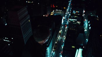 Movie still from “Margin Call” (2011), directed by J.C. Chandor – A man standing on the side of a tall building; Wide shot, Overhead angle
