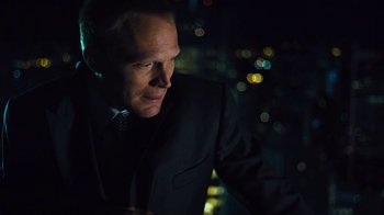 Movie still from “Margin Call” (2011), directed by J.C. Chandor – A person wearing a suit and tie; Close Up shot, Over the shoulder angle