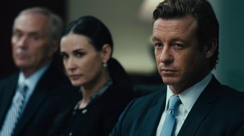 Movie still from “Margin Call” (2011), directed by J.C. Chandor – A man and a woman sitting next to each other; Close Up shot, Over the shoulder angle